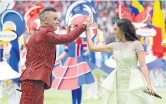  ??  ?? Robbie Williams and Aida Garifullin­a perform during the opening ceremony.