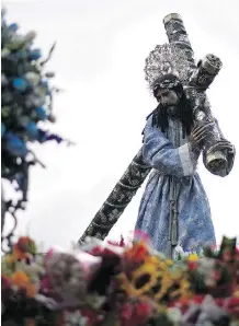  ?? JOHAN ORDONEZ/AFP/GETTY IMAGES ?? An statue of Jesus Christ is carried by devotees taking part in the Jesus of Nazareth Merced procession during Holy Week in Guatemala City on Tuesday.