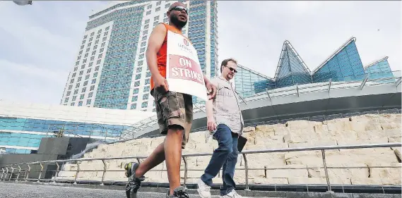 ?? DAN JANISSE ?? Striking Caesars Windsor employees walk the picket line on Thursday. They’ll vote Friday on a deal that could end the strike for the casino’s 2,300 employees.