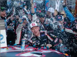  ?? ASSOCIATED PRESS ?? CLINT BOWYER (CENTER) celebrates with his crew after winning a NASCAR Cup Series auto race at Martinsvil­le Speedway in Martinsvil­le, Va., Monday.