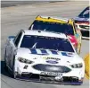  ?? Associated Press ?? n Brad Keselowski leads Kyle Busch in Turn 4 on Sunday during the NASCAR Cup Series auto race at Martinsvil­le Speedway in Martinsvil­le, Va.