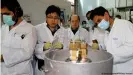  ??  ?? IAEA inspectors, shown here at the Natanz power plant in 2014, found uranium particles in undisclose­d nuclear sites in Iran