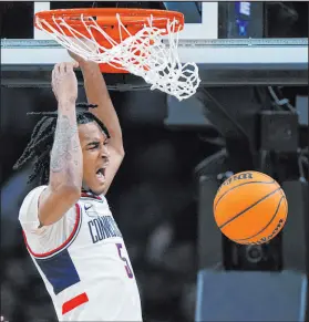  ?? Steven Senne The Associated Press ?? Connecticu­t guard Stephon Castle dunks for two of his 16 points as the Huskies rolled into the Elite Eight.