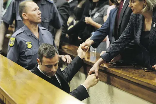  ?? Herman Verwey / Gett y Imag es ?? Oscar Pistorius leaves Pretoria High Court after being sentenced Tuesday to five years in the 2013 shooting of his girlfriend. The former athlete, known as the ‘Blade Runner,’ will likely serve 10 months in jail and the rest under house arrest.