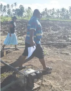  ??  ?? Minister for Agricultur­e Inia Seruiratu with field Officer from Nadi inspecting the irrigation system use by the farmers.