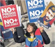  ??  ?? A woman holds up posters with the image of Venezuela’s jailed opposition leader Leopoldo Lopez during a protest demanding the release of Lopez and other jailed opposition leaders, in Madrid, yesterday.