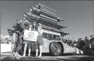  ?? AP/DARRON CUMMINGS ?? Scott Dixon (left) of New Zealand, celebrates with his wife, Emma, and children, Poppy and Tilly, after winning the pole for the Indianapol­is 500 on Sunday at the Indianapol­is Motor Speedway.