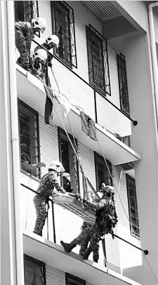  ??  ?? Firemen rescuing victims during a fire drill at the Tawau General Hospital yesterday. Eleven persons ‘sustained’ varying degree of injuries in the exercise which also involved the police, civil defence force and Red Crescent.