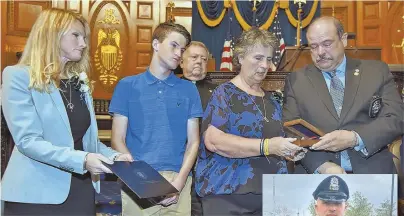  ?? STAFF PHOTOS BY PATRICK WHITTEMORE; COURTESY PHOTO, RIGHT ?? HONORING BRAVERY: The family of slain Auburn police officer Ronald Tarentino Jr. (inset), from left, wife Tricia, son Kyle, mother Sharon and father Ronald Sr., receive the George L. Hanna Medal of Honor yesterday at the State House.