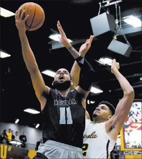  ?? Matt Marton ?? The Associated Press UNR forward Cody Martin puts up a shot against Loyola-chicago forward Christian Negron during the first half of the No. 5 Wolf Pack’s 79-65 victory Tuesday in Chicago.