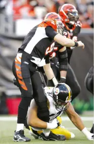  ??  ?? Carson Palmer is taken down by the Steelers’ Kimo von Oelhoffen during a 2006 P ayoff game