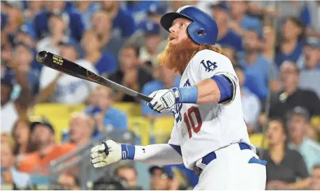  ?? JAYNE KAMIN-ONCEA, USA TODAY SPORTS ?? Justin Turner’s two-run homer broke a tie in the sixth inning Tuesday as the Dodgers seized advantage in the World Series with a 3-1 victory against the Astros in Game 1.