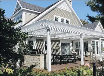  ??  ?? This custom pergola by Sun Louvre extends outdoor living and suits the home’s architectu­re.