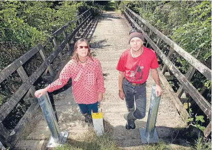  ?? Photo: MAARTEN HOLL/FAIRFAX NZ ?? A bridge too far: Gary and Lynne Hertnon at the bridge, off Kaitawa Rd in Otaki Gorge, which has been closed because it is unsafe – cutting access to their lifestyle block. They are now pursuing legal action.