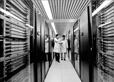  ?? PROVIDED TO CHINA DAILY ?? Two engineers examine the equipment of Tianhe at the National Supercompu­ter Center in Tianjin.