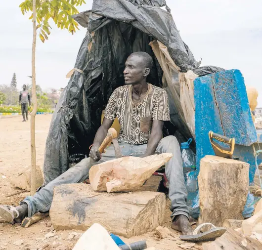  ?? CARMEN ABD ALI/THE NEW YORK TIMES PHOTOS ?? Malaw Sow, a sculptor, works on his pieces May 27 in Dakar, Senegal. The arts have descended on the capital for its first pandemic-era biennale.