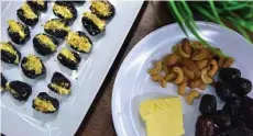  ?? ?? Social media is flooded with testimonie­s of people eating butter-filled dates. — Bernama photo