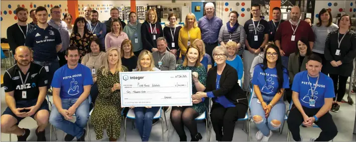  ??  ?? Staff at Integer in New Ross present a cheque for €40,000 to Leigh Kenny and Pauline Lawlor of Pieta house, Wexford.