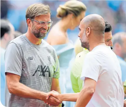  ??  ?? Jurgen Klopp and Pep Guardiola were all smiles at Wembley last Sunday. Now the real work has started