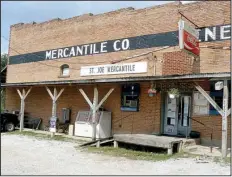  ?? Special to the Democrat-Gazette ?? Janis White Busbee, 74, owner of St. Joe Mercantile, talks with her neighbor Bill Davis on Tuesday about selling bricks from the store that was destroyed by fire. Davis ventured that they would be worth $1 apiece. The store stood for 112 years.