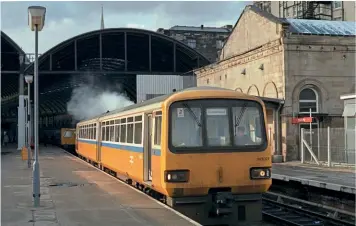  ??  ?? Nos. 143020-25 were sponsored by the Tyne & Wear PTE, so wore its yellow & white colours. No. 143021 is pictured leaving Newcastle for Sunderland on February 14, 1987.