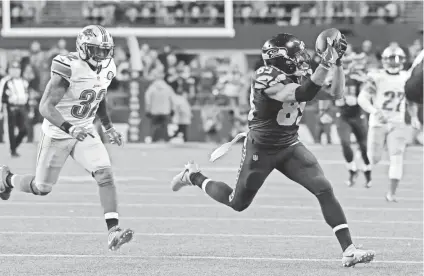  ?? KIRBY LEE/USA TODAY SPORTS ?? Seahawks wide receiver Doug Baldwin (89) catches a pass in front of Lions strong safety Tavon Wilson during Saturday’s NFC wild-card game at Seattle.