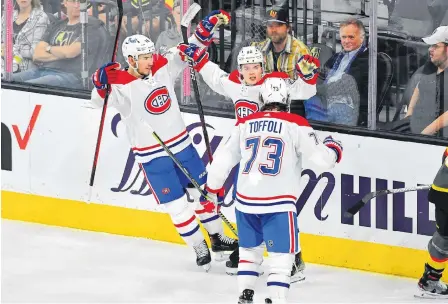  ?? USA TODAY SPORTS ?? Montreal Canadiens right winger Cole Caufield (middle) celebrates with Montreal Canadiens center Nick Suzuki (left) and Montreal Canadiens right wing Tyler Toffoli (73) after scoring a second-period goal against the Vegas Golden Knights in Game 1 of the 2021 Stanley Cup Semifinals at T-mobile Arena in Las Vegas on Monday.