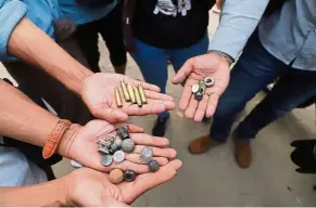  ?? — AFP ?? Weapons of choice: Protesters holding bullet cartridges after security forces fired on demonstrat­ors at a rally in Mandalay.