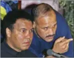  ?? GREG BAKER — THE ASSOCIATED PRESS FILE ?? FILE – In this file photo, Muhammad Ali, left, is joined by David Bey during a news conference in Beijing. Bey, a former heavyweigh­t boxing champ from Philadelph­ia nicknamed “Hand Grenade,” died Thursday in a constructi­on accident in Camden.