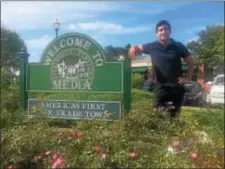  ?? PEG DEGRASSA-- DIGITAL FIRST MEDIA ?? Film director Omri Dorani stands at the gateway sign to Media Borough. Dorani, together with film team members Media native Jeff Ayars, Simone Policano and Robert Harmon, hope to win a competitio­n sponsored by wellknown filmmakers Mark and Jay Duplass....