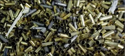  ?? AP PHOTO/LYNNE SLADKY ?? In this 2016 file photo, empty bullet casings sit in a container at the National Armory gun store and gun range in Pompano Beach, Fla.