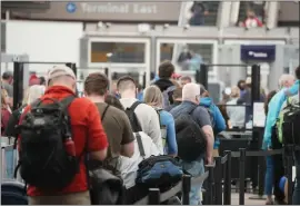  ?? DAVID ZALUBOWSKI — THE ASSOCIATED PRESS ?? Travelers queue up at the north security checkpoint in the main terminal of Denver Internatio­nal Airport in May. Airlines canceled more than 1,000flights by midmorning Friday as they try to recover from storms that raked parts of the country.