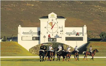  ?? /Bloomberg ?? Business as usual: Polo players participat­e in a game at the luxury Val de Vie estate in Stellenbos­ch. Many wealthy South Africans still live in an alternate reality of glamour and luxury while millions of people around the country still endure abject...
