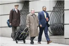  ??  ?? BALTIMORE: William Porter (right), one of six Baltimore city police officers charged in connection with the death of Freddie Gray, walks into a courthouse with his attorney Joseph Murtha (center) for jury selection in his trial yesterday. —AP