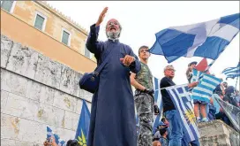  ?? ARISTIDIS VAFEIADAKI­S / ZUMA PRESS ?? Protesters wave Greek flags in protest of an agreement that renames Greece’s northern neighbor North Macedonia, outside the Greek Parliament in Athens on Saturday. Nationalis­ts on both sides protested in several locations.