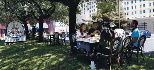  ?? PHOTOS BY NHAT V. MEYER —STAFF PHOTOGRAPH­ER ?? A group dines outside at Pho Ha Noi restaurant in Cupertino on July 6. Owner Helen Nguyen was continuing to offer outdoor dining at her Cupertino and San Jose restaurant­s after Gov. Gavin Newsom sent armed state agents over the Fourth of July weekend to warn 6,000 restaurant­s of violations for serving food on site.