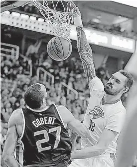  ?? [AP PHOTO] ?? Oklahoma City’s Steven Adams, right, dunks on Utah Jazz center Rudy Gobert during Monday’s NBA game in Salt Lake City.