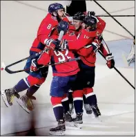  ?? AP/PABLO MARTINEZ MONSIVAIS ?? Washington Capitals teammates mob forward T.J. Oshie (center) who scored the first goal in a 6-2 victory over the Vegas Golden Knights in Game 4 of the Stanley Cup Final.