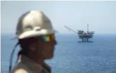  ?? AFP ?? An employee from the Israeli gas-drilling Tamar platform in the Mediterran­ean Sea off the coast of Israel