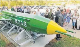  ?? AP ?? A group gathers around a GBU43B, or massive ordnance air blast weapon, on display at the Air Force Armament Museum on Eglin Air Force Base near Valparaiso, Florida.