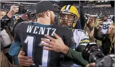  ?? MEDIANEWS GROUP FILE PHOTO ?? Eagles rookie quarterbac­k Carson Wentz, left, and Packers quarterbac­k Aaron Rodgers embrace after the Packers defeated the Eagles in Nov. of 2016. Wentz had better times against Rodgers after that, but he’s fallen on much harder times this season.