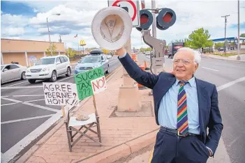  ?? EDDIE MOORE/ JOURNAL ?? Fabio Macchioni, impersonat­ing U.S. Sen. Bernie Sanders, who opposed a soda tax in Philadelph­ia, waves to motorists while encouragin­g them to vote against a proposed tax on sugary beverages, at Cerrillos Road and St. Francis Drive on Wednesday.