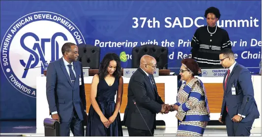  ?? Picture: GCIS ?? REACHING OUT: SADC chairperso­n President Jacob Zuma with the newly sworn in SADC executive secretary Dr Stergomena Laurens Tax and her family during the official closing ceremony of the 37th Ordinary Summit of Heads of State and Government at the...