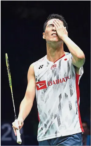  ??  ?? Joy and agony: Malaysia’s Liew Daren (top) holds his head in disbelief after his quarter-final victory while Japan’s Kanta Tsuneyama (inset) reacts to his loss yesterday.