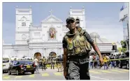  ?? ERANGA JAYAWARDEN­A / AP ?? Sri Lankan soldiers secure the area around St. Anthony’s Shrine after a blast in Colombo. More than 200 people were killed and hundreds more injured in eight blasts that rocked churches and hotels.