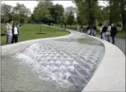  ?? JANE MINGAY — THE ASSOCIATED PRESS FILE ?? Members of the public visit the “Diana, Princess of Wales Memorial Fountain,” which was re-opened following four months of repairs, in London’s Hyde Park.