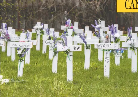  ?? PETER J THOMPSON/NATIONAL POST/FILES ?? Crosses stand outside the Camilla Care Community, a long-term care facility in Mississaug­a, Ont., where 50 people died of COVID-19.