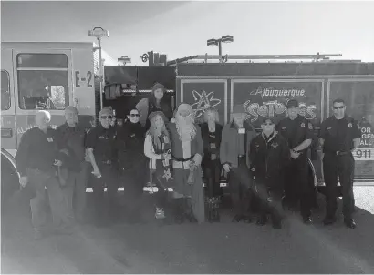  ??  ?? City Councilor Trudy Jones, to Santa’s right, and her staff partnered with the Woodworker­s Associatio­n and the Albuquerqu­e Fire Department to bring Santa to the children at CLNkids.