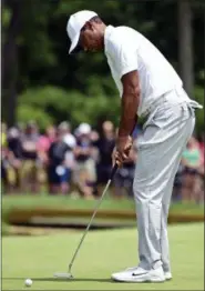  ?? DAVID DERMER — THE ASSOCIATED PRESS ?? Tiger Woods putts on the ninth hole during the first round of the Memorial golf tournament Thursday in Dublin, Ohio.