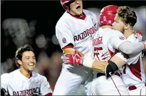  ?? NWA Democrat-Gazette/ANDY SHUPE ?? Arkansas designated hitter Luke Bonfield (right) is mobbed by teammates Dominic Fletcher (from left), Grant Koch and Jake Arledge after his single up the middle scored Jax Biggers from second base to give the Razorbacks a 4-3 victory Friday over...